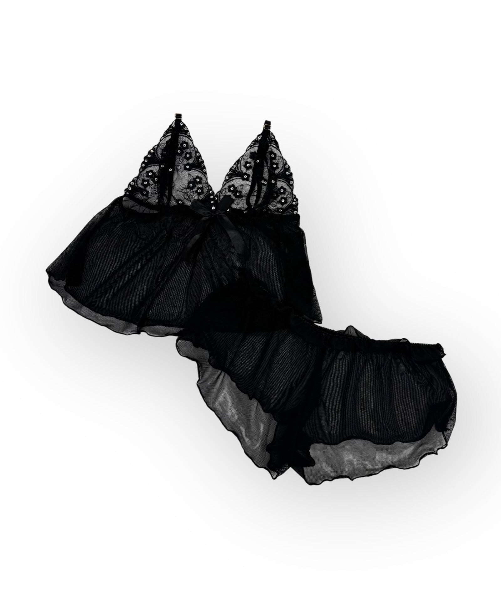 Flatlay black lace lingerie set on a white background