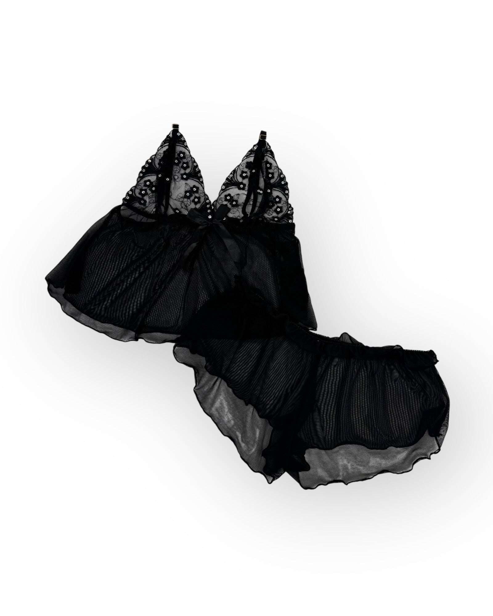 Flatlay black lace lingerie set on a white background