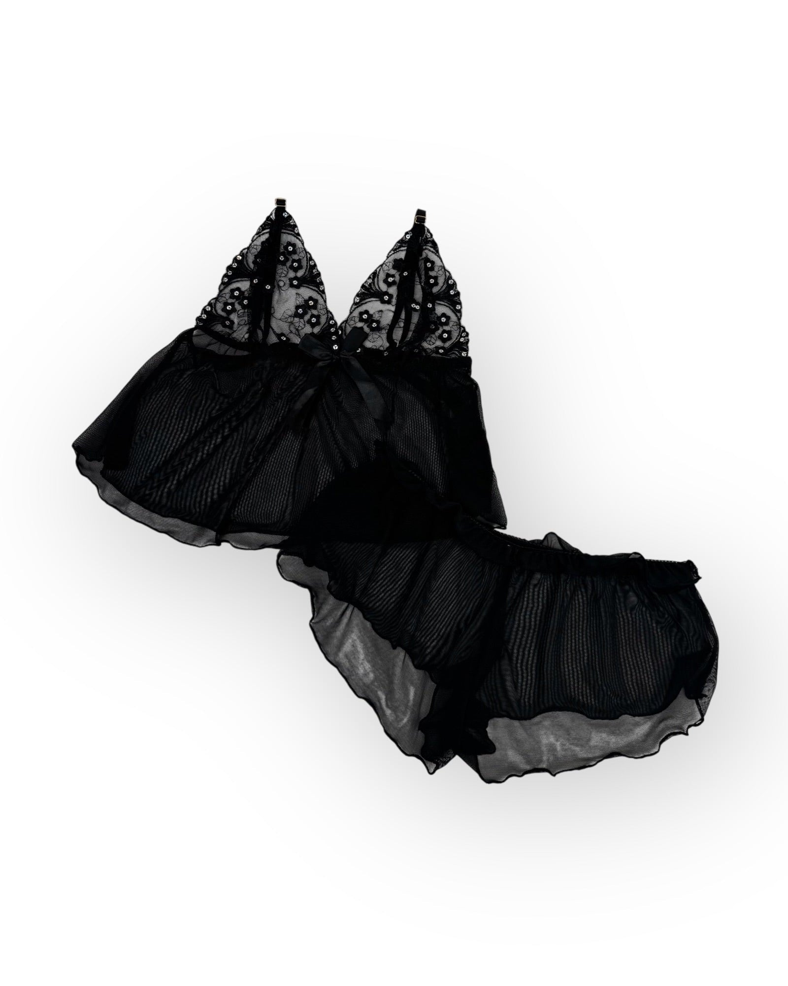 Flatlay black lace lingerie set on a white background