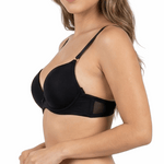 Woman wearing a black bra and panties set on a white background