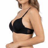 Woman wearing a black bra and panties set on a white background