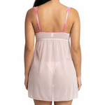 Woman wearing a sheer pink nightgown with thin straps on a white background