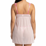 Woman wearing a sheer pink nightgown with thin straps on a white background