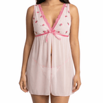 Woman wearing a pink lace nightgown on a white background
