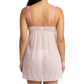 Woman wearing a sheer pink nightgown with thin straps on a white background