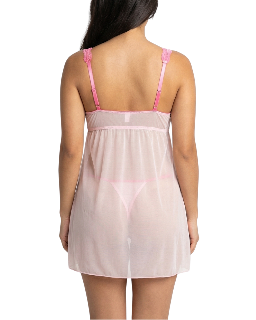 Woman wearing a sheer pink nightgown with thin straps on a white background