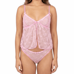 Woman wearing a pink lace lingerie set on a white background