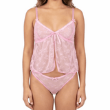 Woman wearing a pink lace lingerie set on a white background