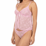 Woman wearing a pink lace lingerie set on a white background