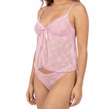 Woman wearing a pink lace lingerie set on a white background