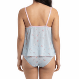 Woman wearing a light blue satin nightgown with pink floral pattern on a white background