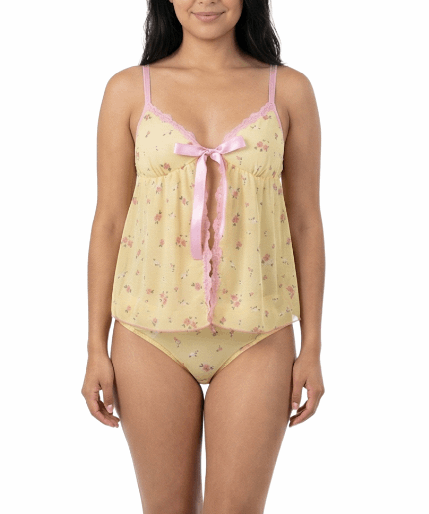 Woman wearing a yellow floral nightgown with pink trim on a white background