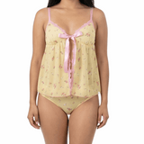 Woman wearing a yellow floral nightgown with pink trim on a white background