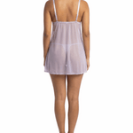 Woman wearing a sheer nightgown on a white background
