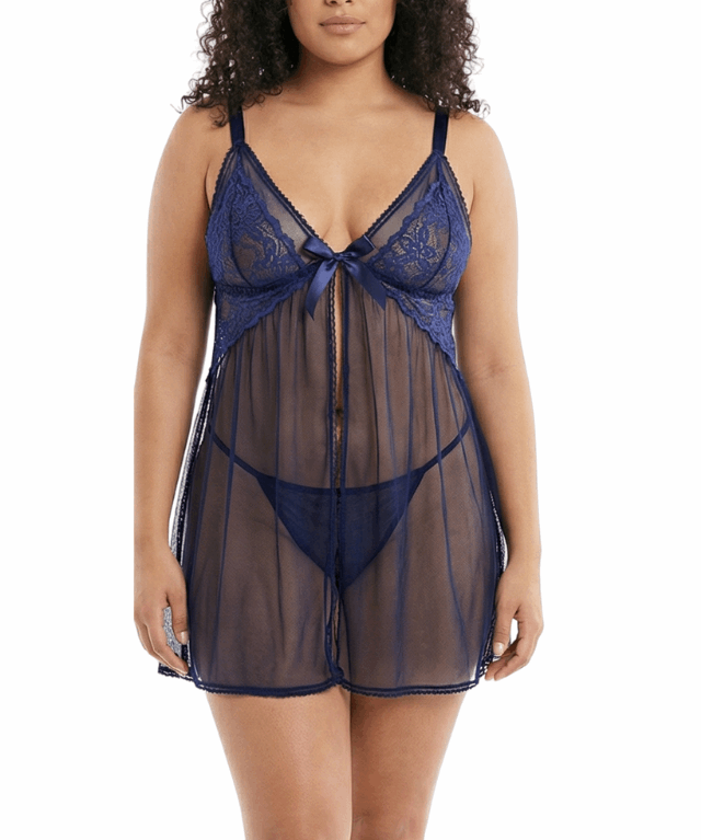 Woman wearing a navy blue lace nightgown on a white background