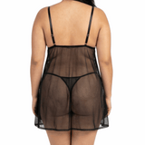 Person wearing a sheer black nightgown on a white background