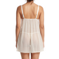 Woman wearing a sheer white nightgown with thin straps on a white background
