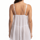White babydoll dress worn by a model on a white background