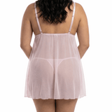 Woman wearing a sheer pink nightgown on a white background