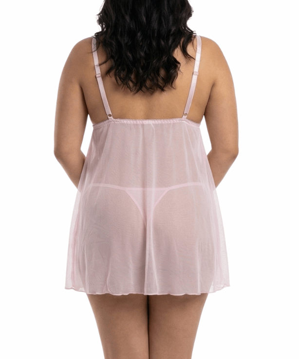 Woman wearing a sheer pink nightgown on a white background
