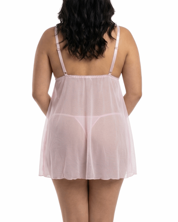 Woman wearing a sheer pink nightgown on a white background