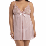 Woman wearing a light pink lace nightgown on a white background