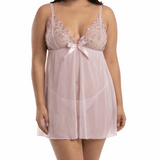 Woman wearing a light pink lace nightgown on a white background