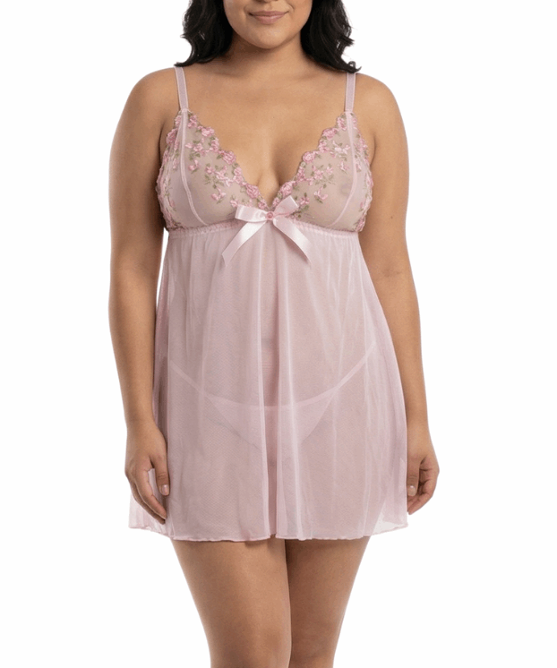 Woman wearing a light pink lace nightgown on a white background