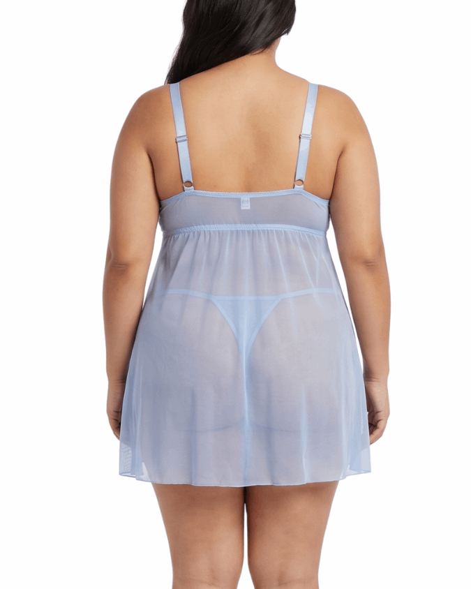 Woman wearing a sheer baby blue nightgown on a white background