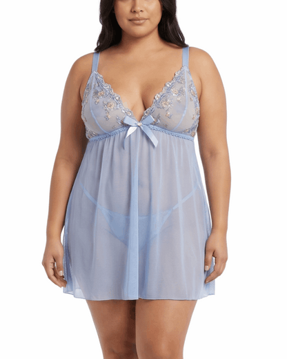 Woman wearing a light blue lace nightgown on a white background