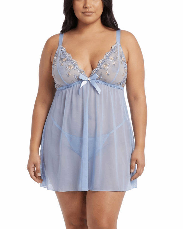 Woman wearing a light blue lace nightgown on a white background