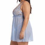 Woman wearing a light blue lace nightgown on a white background