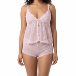 Woman wearing a pink lace cami set on a white background