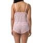 Woman wearing a pink lace cami set on a white background