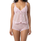 Woman wearing a pink lace cami set on a white background