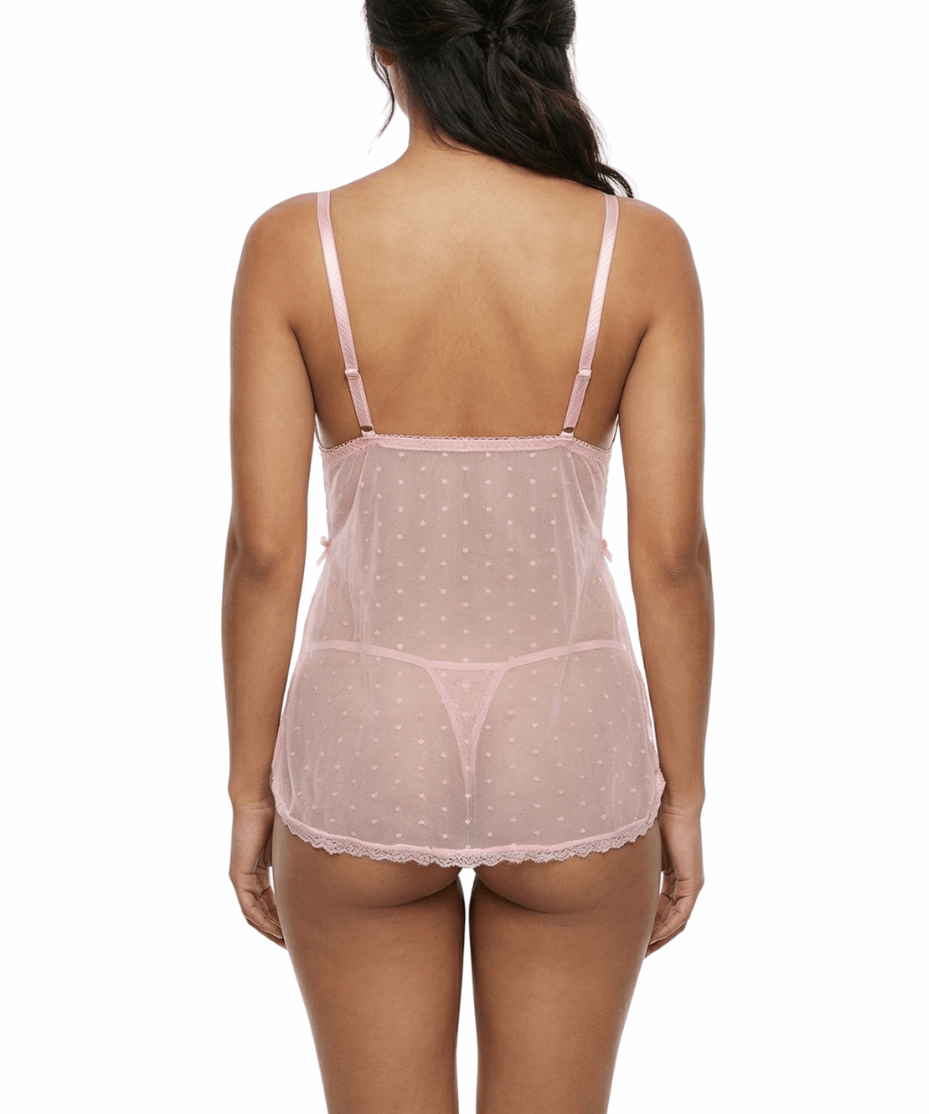 Woman wearing a sheer pink nightgown on a white background