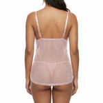 Woman wearing a sheer pink nightgown on a white background
