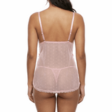 Woman wearing a sheer pink nightgown on a white background