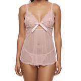 Woman wearing a pink lace lingerie set on a white background