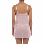 Woman wearing a sheer pink nightgown on a white background