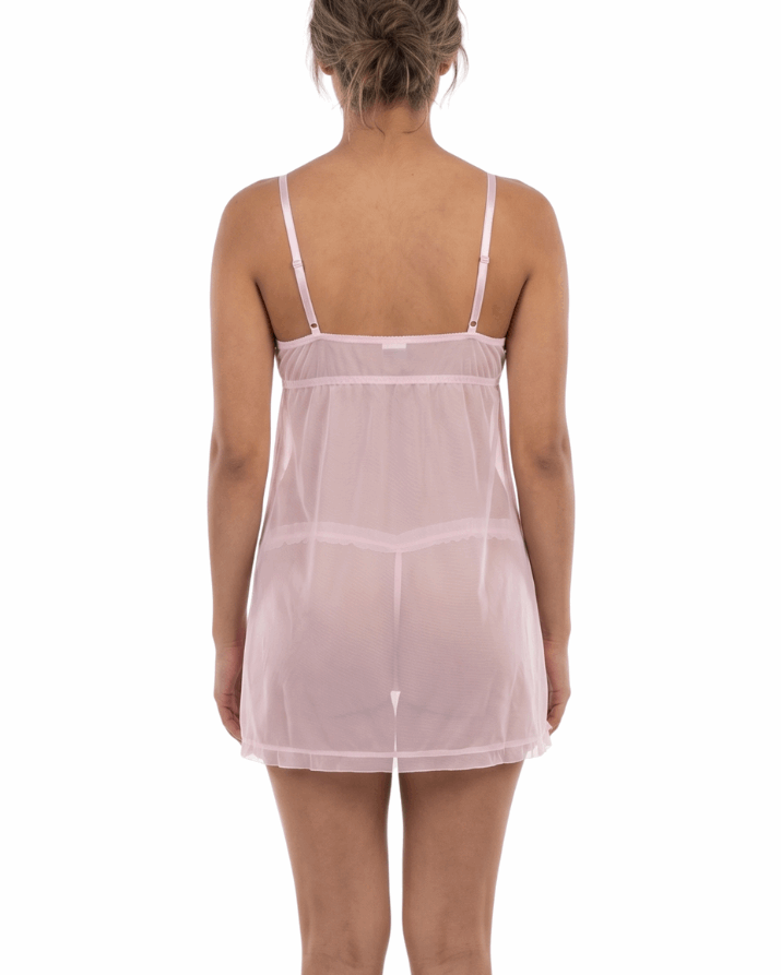 Woman wearing a sheer pink nightgown on a white background