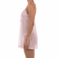 Woman wearing a light pink slip dress against a white background