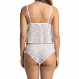 Woman wearing a white floral lingerie set on a white background