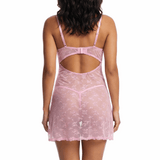 Woman wearing a pink lace nightgown on a white background
