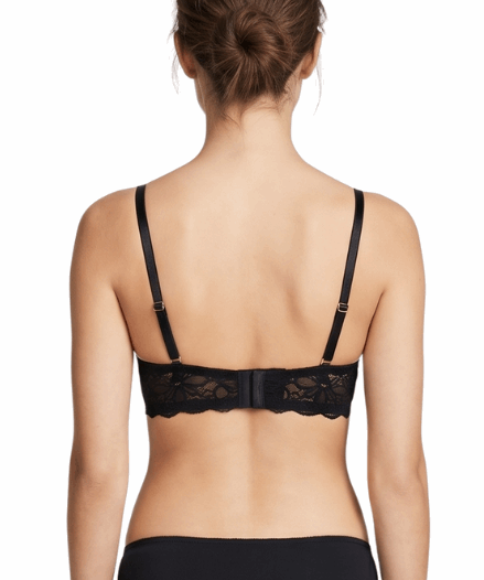 Woman wearing a black bra on a white background