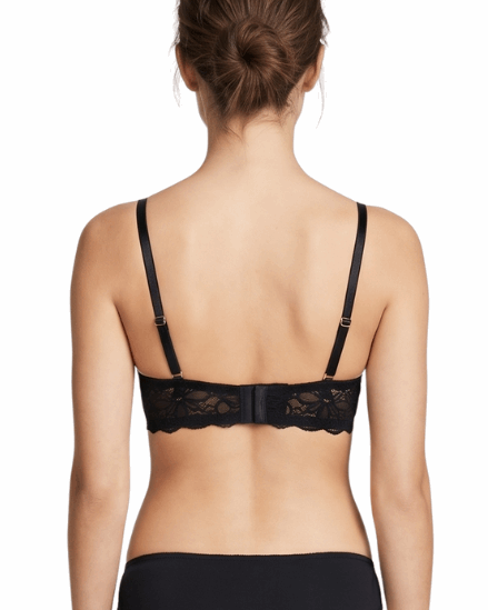 Woman wearing a black bra on a white background