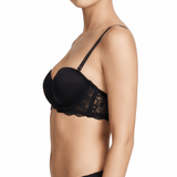 Woman wearing a black bra on a white background