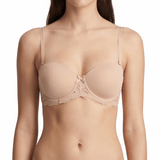 Woman wearing a beige bra and panties set on a white background