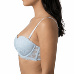 Woman wearing a light blue bralette on a white background
