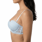 Woman wearing a light blue bralette on a white background